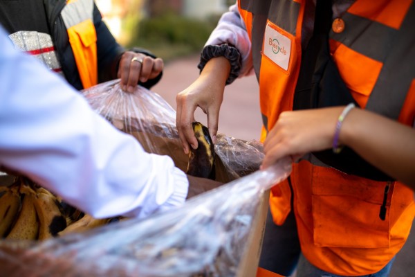 Zoom sur des bénévoles Biocycle autour d'un carton de bananes abimés
